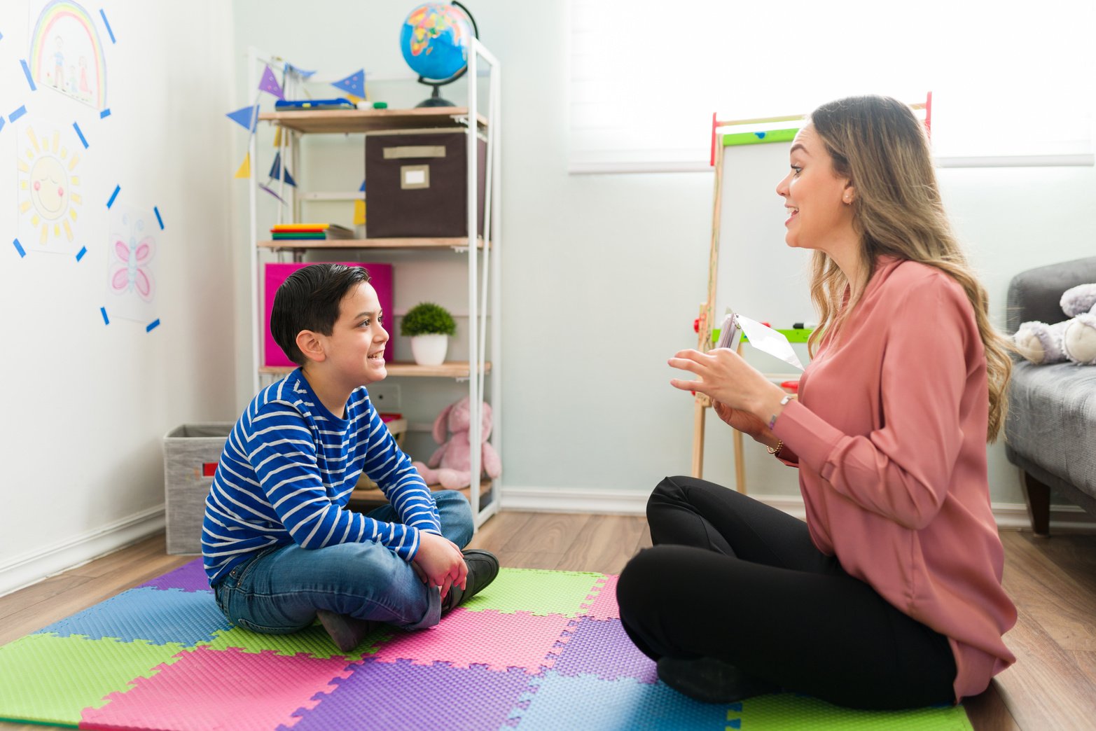 Side view of a caucasian boy making sounds during speech therapy